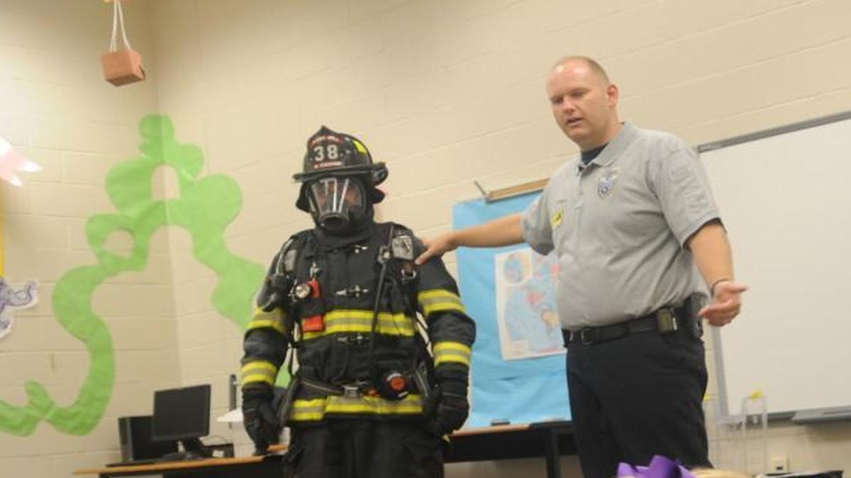 
Firefighter Myles Therrien and fire marshal Russell Rogers speak to kindergarten students Monday morning at Pleasant Knoll Elementary School.
