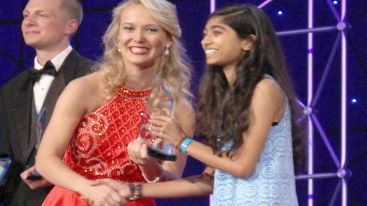 Nation Ford High student Sabah Bhamani (right) receives her award at FBLA nationals.