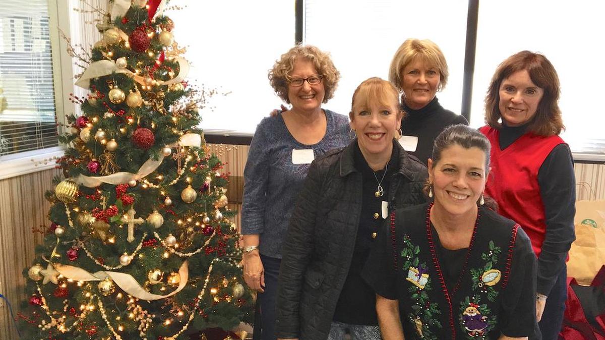 Palisades Women’s Club members from left, Jody Getson, Jackie Canarick, Sue Magnuson, JoAnne Metz and Ruth Benson decorated trees Nov. 17 at Holy Angels in Belmont, N.C.