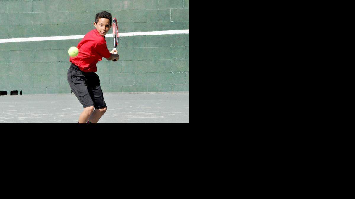 
Marco Ward, 12, of Lake Wylie gets in tennis practice with his father, Sherley, during spring break March 31 at River Hills Country Club in Lake Wylie.
