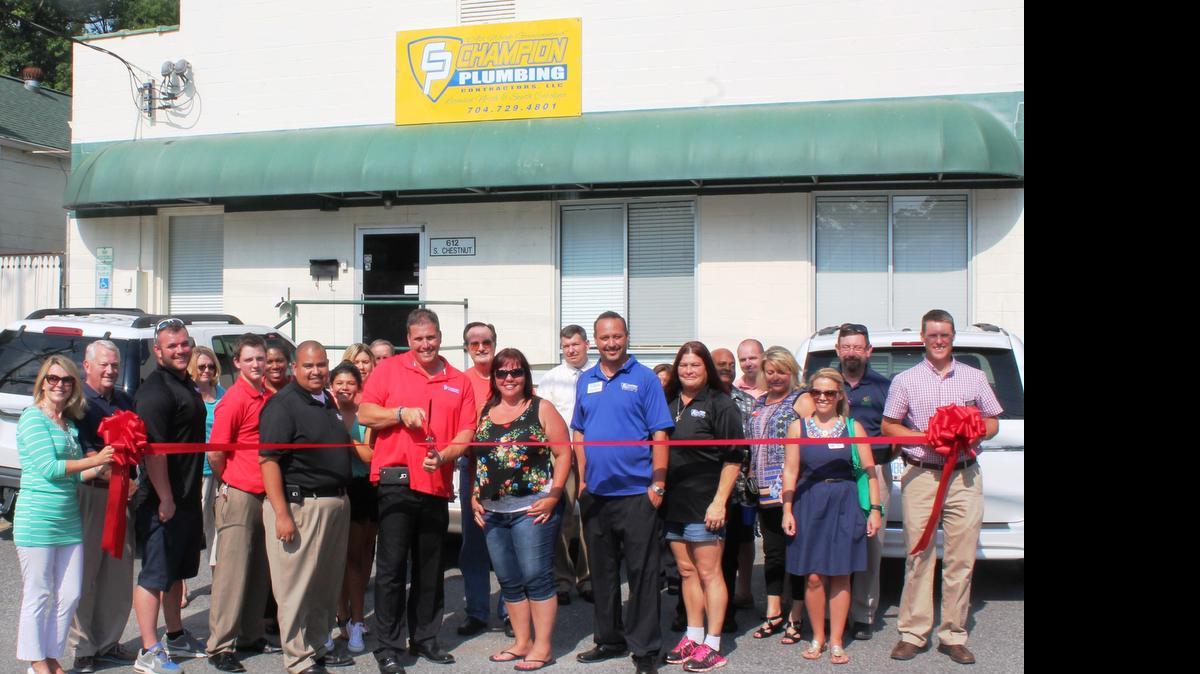 
Champion Plumbing President Robert Johnson and wife Amber cut the ribbon during a celebration at the new Gastonia, NC, location with staff and Montcross Area Chamber of Commerce members, including board members Jennifer Church and Jason Ramey, holding the ribbon.
