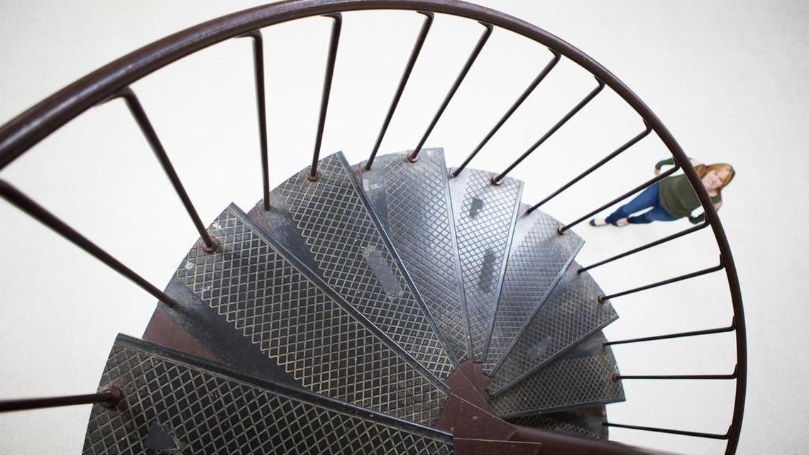Writer Melissa Oyler looks toward the top of the spiral staircase that she used to climb for ballet and piano lessons in the 1980s.