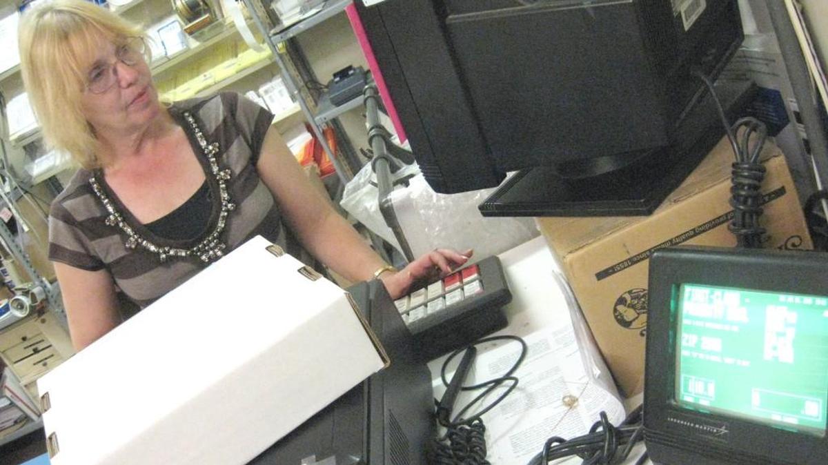 Dian Frakowski weighs a package at the Lake Wylie Post Office that used to be in Lake Wylie Plaza. Local mail is available at the Clover station and officials say they are looking for another Lake Wylie location for U.S. mail services.