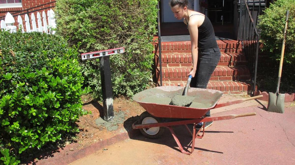 Allison Brann pours cement for one of her Little Free Library boxes.