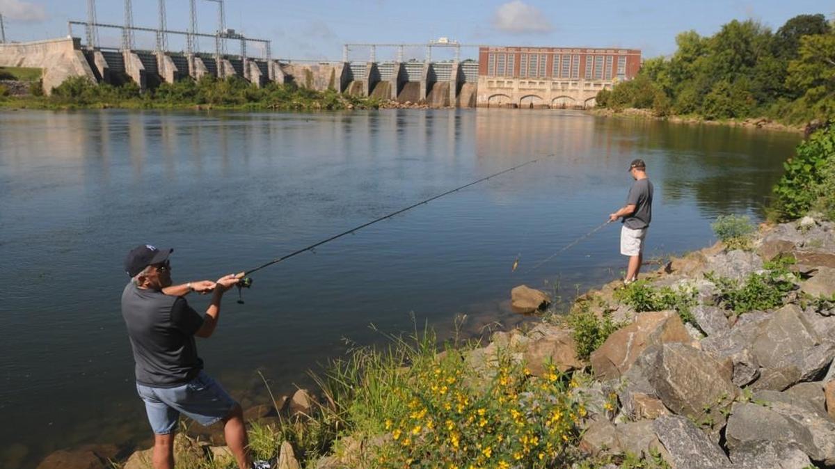 Two men fish along the banks of the Catawba river near the dam at the Fort Mill Access Area. The city of Tega Cay and Duke Energy are working on a plan to create a new recreation facility in the area that would be called Catawba Park. The design phase is nearly complete, but federal regulator has to approve plans before they can proceed.