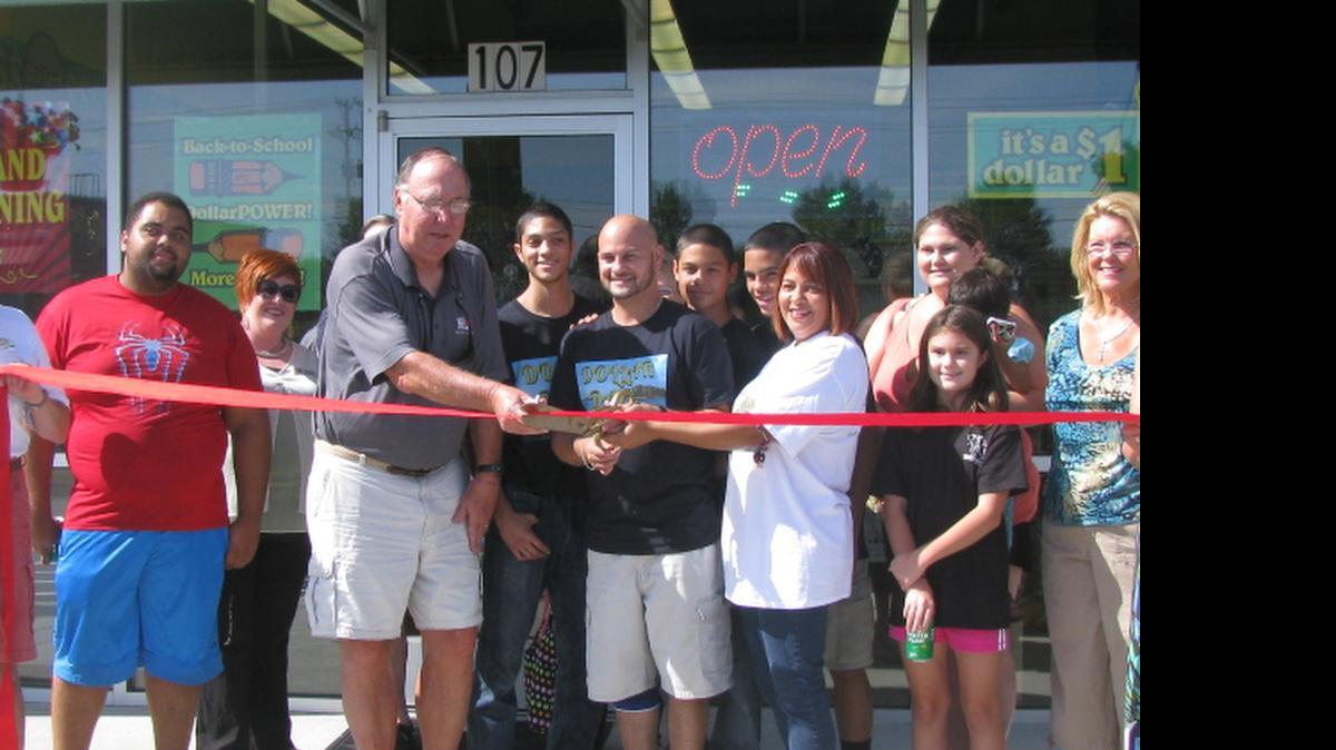 
Yoseph and Jennifer Alejandro, at right, cut the ribbon during the grand opening celebration July 11 for Dollar Daze at The Anchor Shops with Lake Wylie Chamber of Commerce members including chairman Charles Wood, left.
