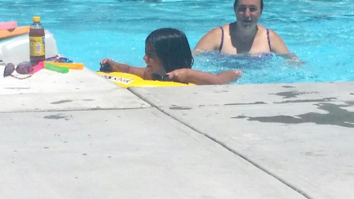 Teacher Amy Harris spends her summer break teaching children how to swim.