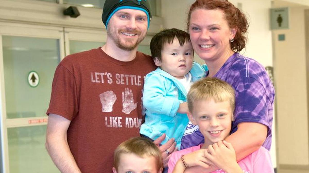 
The Ashe family pictured on their arrival from China with their adopted daughter, Lainey. From left, Jeremy, Noah, Lainey, Stacey and Gavin Ashe.
