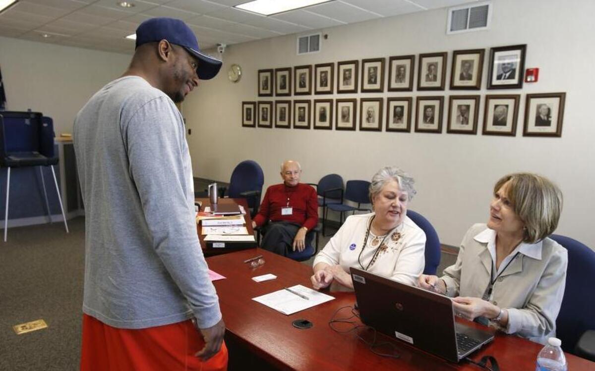 
Voters at Fort Mill Town Hall during Tuesday's Fort Mill school bond referendum. Steven Pringle, left, signs in to vote as Joy Roberts, center, and Linda Hollandsworth work the poll.
