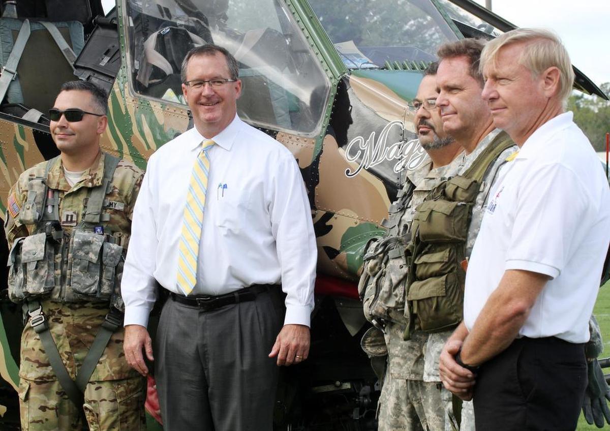 Fort Mill High School Principal Dee Christopher, second from left, stands next to Army pilots and members of the Celebrate Freedom Foundation on Tuesday.