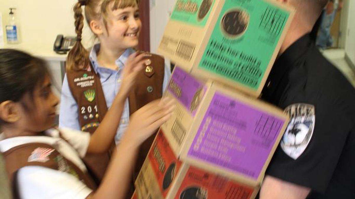 Girl Scouts from Troops 3080 and 2012 delivered 50 cases of Girl Scout cookies to the Fort Mill Police Dept. last week.
