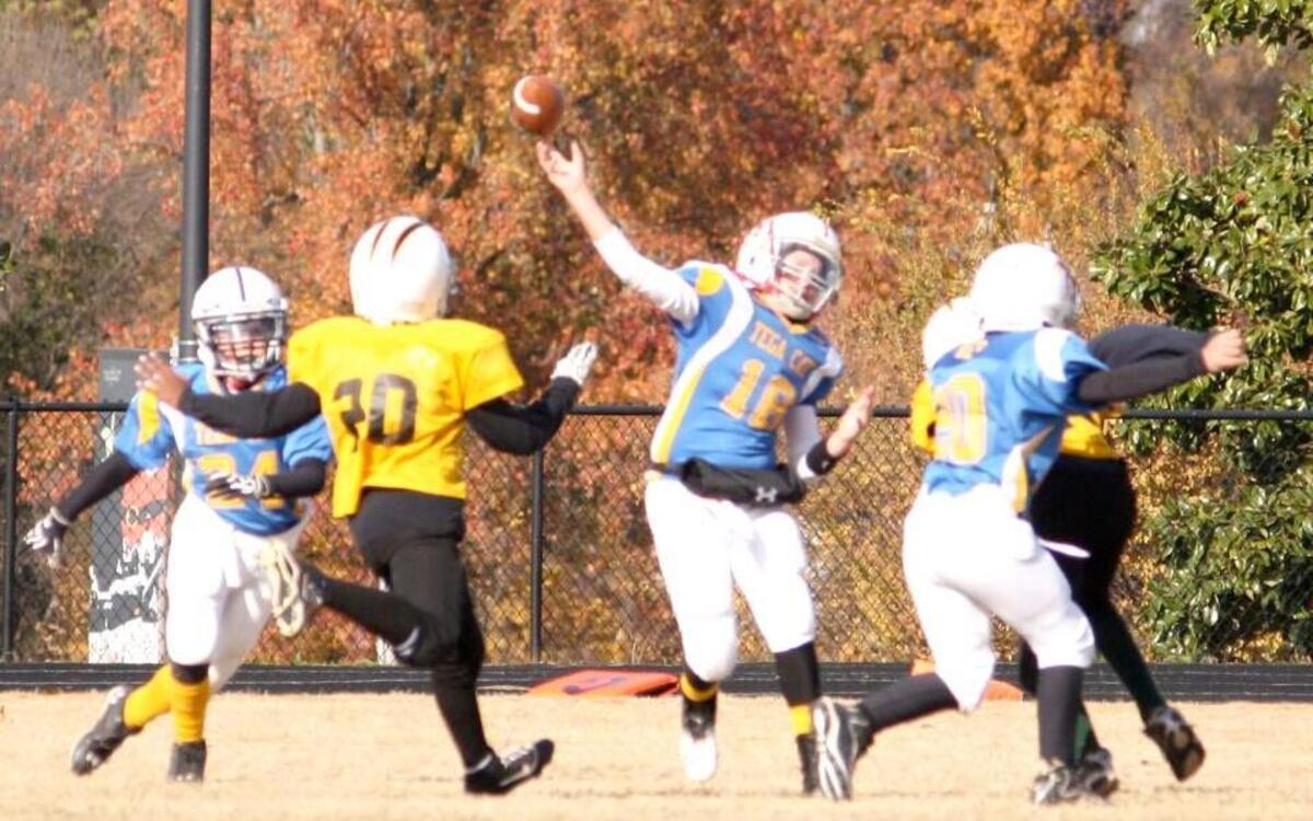 Tega Cay All-Star quarterback Dylan Helms heaves a pass in a 9-10 year-old division game in 2012. Tega Cay has decided to end its tackle football program for kids 11 and younger.