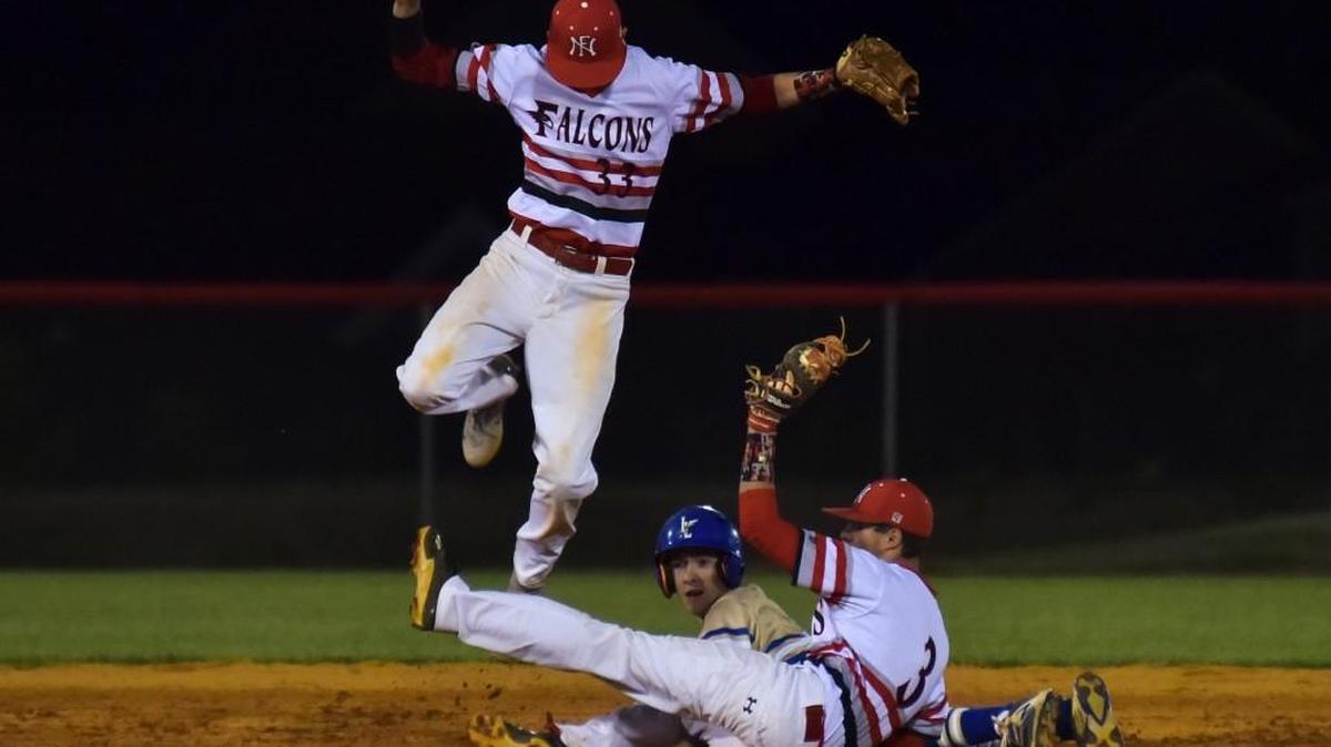 Indian Land's Seth Bevans gets stuck between Nation Ford short stop Kane Luther, left, and second baseman Carter McCram, right, Friday night. Nation ford won, 6-0.