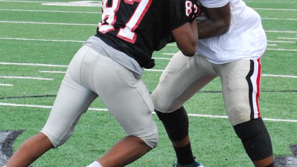 Travell Crosby and Jon Sanders (87) practice blocking each other during a recent Nation Ford spring practice.