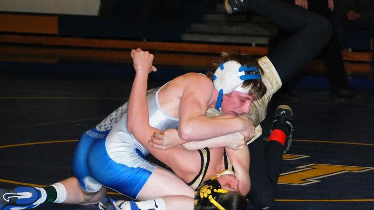 Indian Land’s Austin Ross wrestles during the Warriors match against Crescent as part of the 3A third round playoff match.