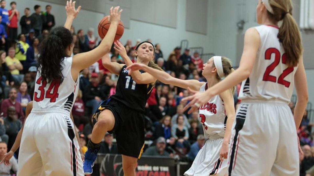 Kimber Haley (11) of Fort Mill looks for the pass as Nation Ford hosted Fort Mill Friday. Both teams begin the playoffs on the road.