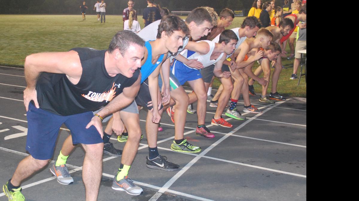 
Runners at the starting line wait to begin the race during the fourth annual Midnight Mile run.
