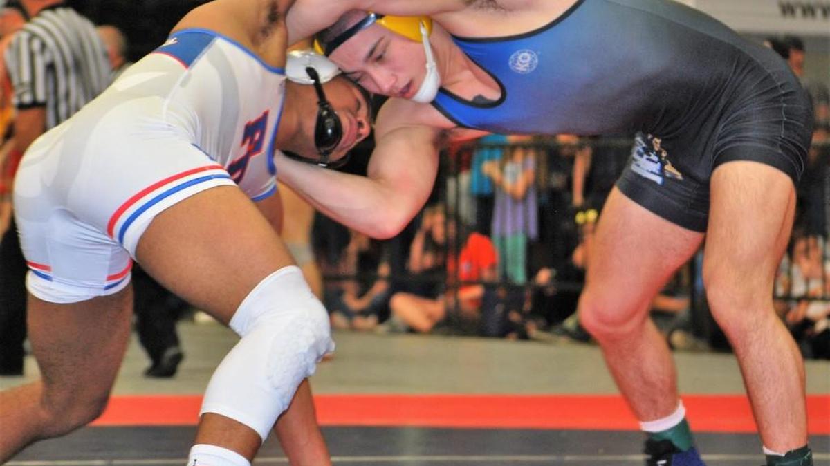 State champion Jake Hart of Fort Mill High, right, wrestles with Fort Dorchester’s Drew Parker, left, in the 5A 152-pound finals.
