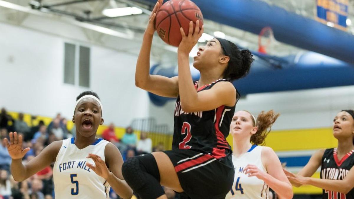 Nation Ford's Ellona Moulds (2) cuts past the Yellow Jacket defense on her way to the basket in a win over Fort Mill .