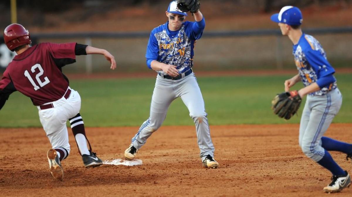 Shown in his Fort Mill High playing days, then Yellow Jacket Brett Netzer, center, completes a third out before Rock Hill's Caleb Hamilton can reach second base.
