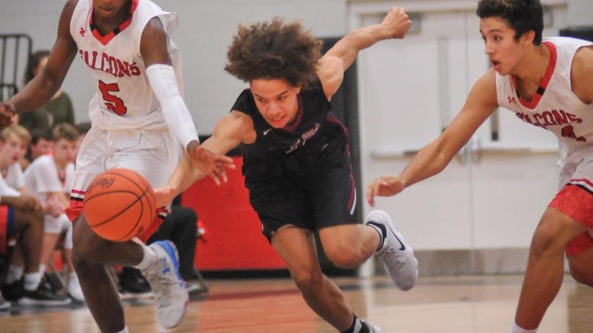 Nation Ford's Zeb Graham (left) and Ben Tuipulotu (right) scramble after the loose ball with Rock Hill's Keshon Fletcher (center) during Tuesday's regional conference boys basketball game. The Falcons won the game, 92-72, in front of the home crowd.