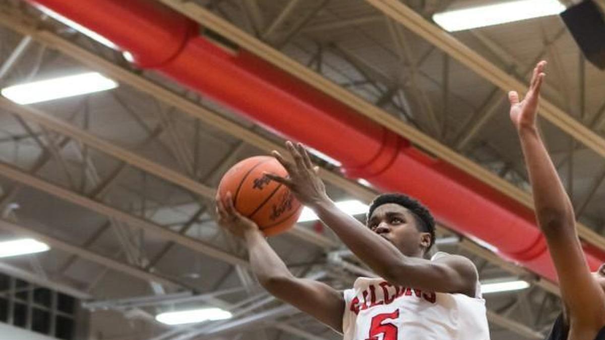 Nation Ford's Zeb Graham drives to the basket as Nation Ford defeats Hillcrest in overtime in 4A playoff action Wednesday.