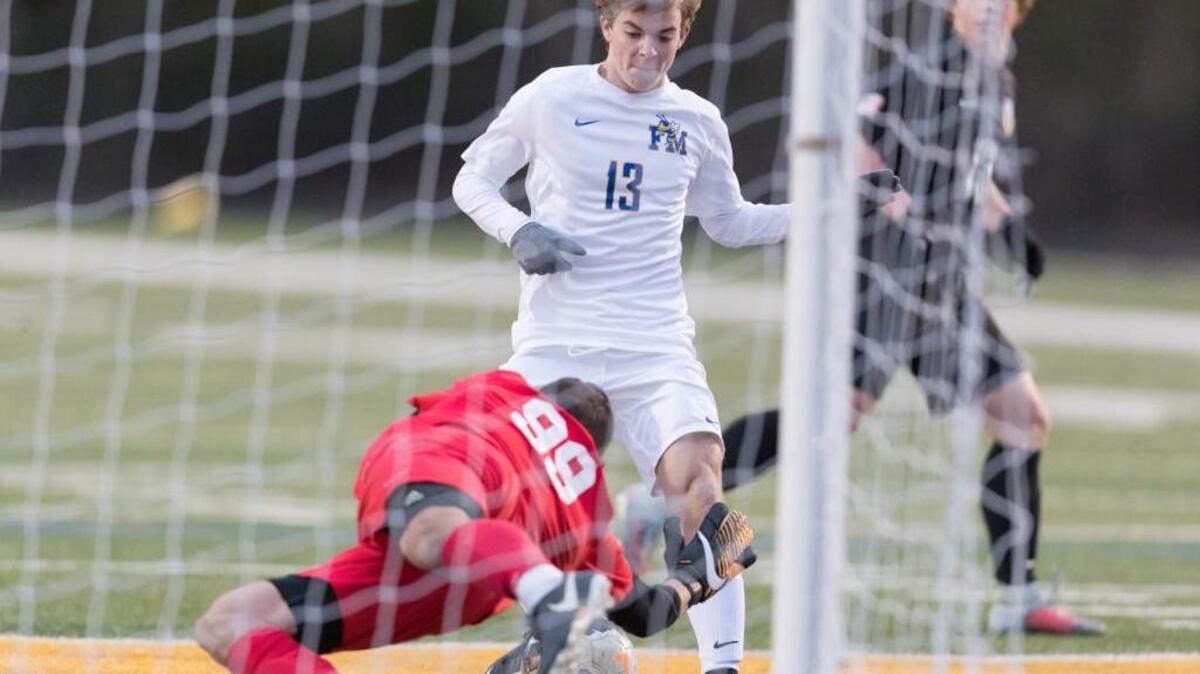 Fort Mill's Braden Held (13) tries unsuccessfully to put the ball over the goal line as Northwestern goalkeeper Davis Hooten stretches back for the save as to Fort Mill hosts Northwestern in boys varsity soccer Wednesday.