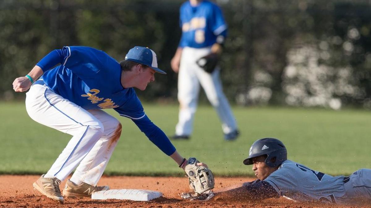 Fort Mill's Logan Stone puts the tag on Clover’s Chris Tribble as Fort Mill hosts Clover in varsity baseball Friday. The Jackets swept the Blue Eagles.