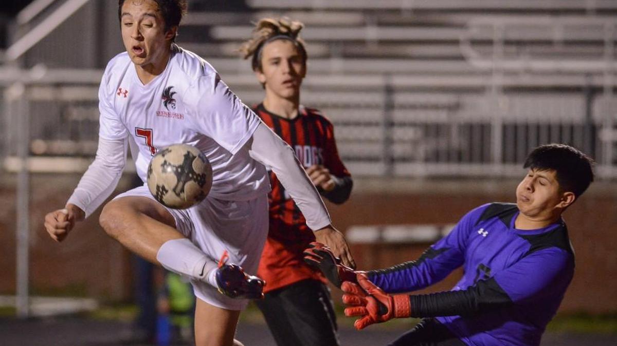 Naiton Ford's Ben Tuipulotu (7) tries to kick the ball past Boiling Spring goalie Emmanuel Ocampo during Friday's Varsity boys soccer game against Boiling Springs.
