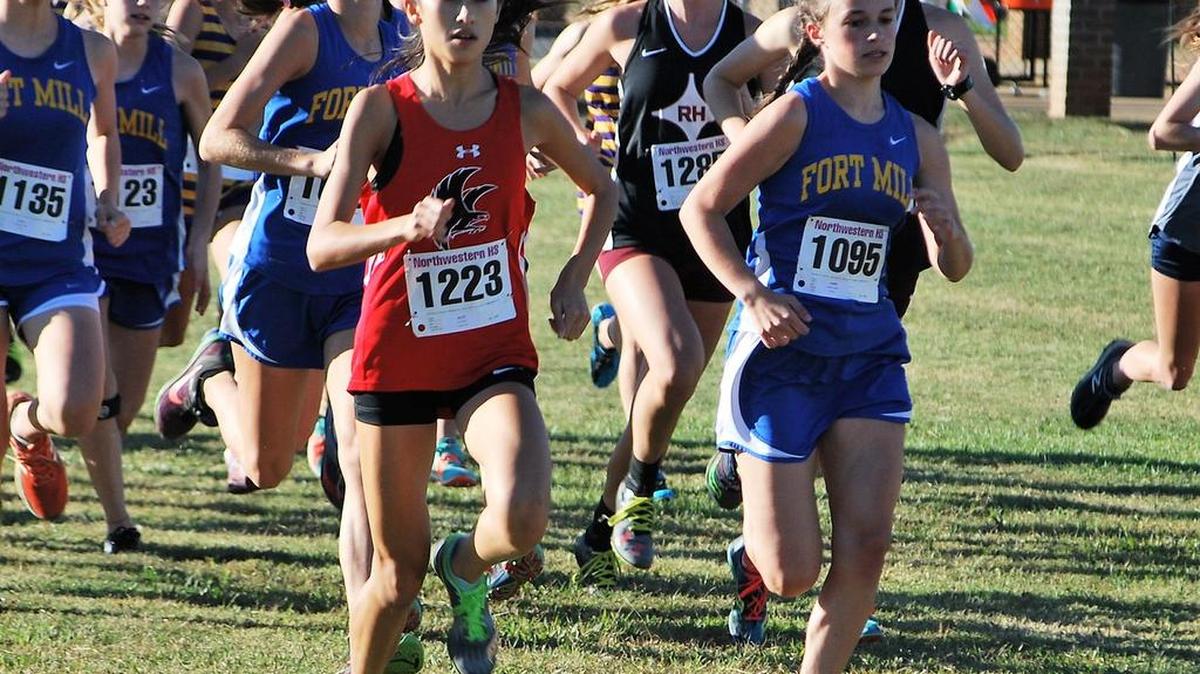 Nation Ford’s Katie Pou, left, won the Region IV girls cross-country championship. Fort Mill’s Sydney George, right, came in second.