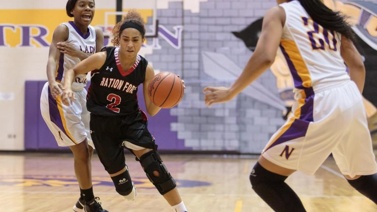 Nation Ford's Ellona Moulds drives down court with the ball as Nation Ford defeats Northwestern Friday to inch closer to a playoff berth.