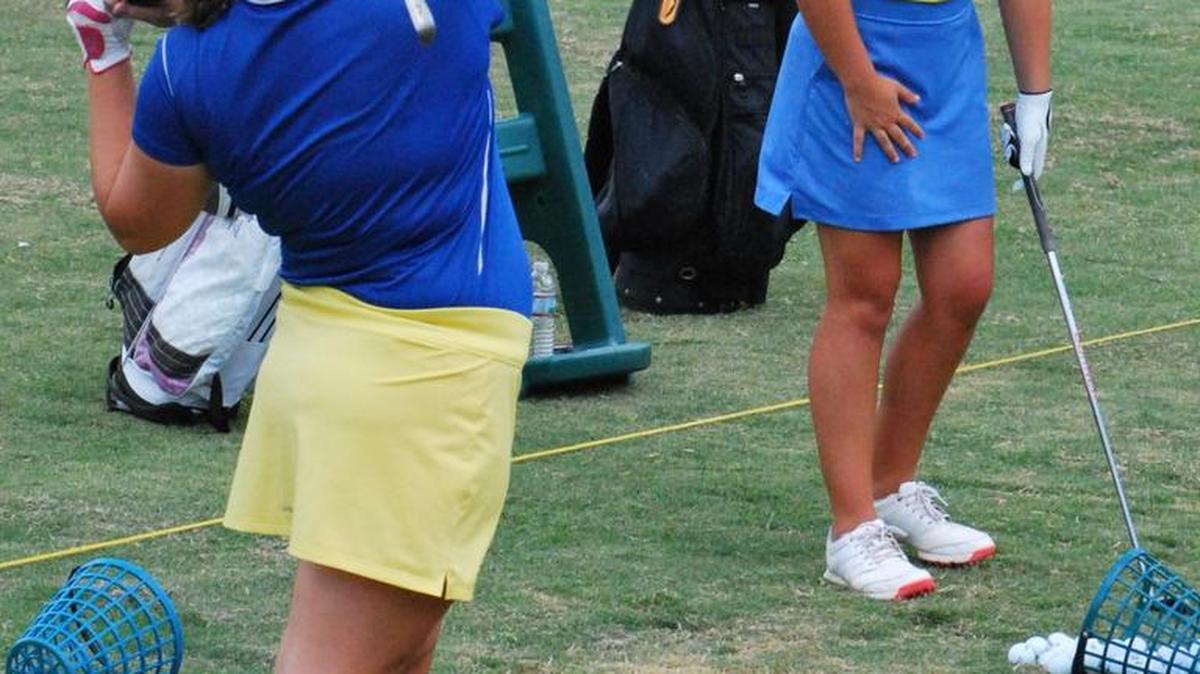 Fort Mill’s Lillian Smith (foreground) and Alexia Van Zanten practice on the driving range at Fort Mill Golf Club. A new season gets underway this week for NaFo and next week for Fort Mill.