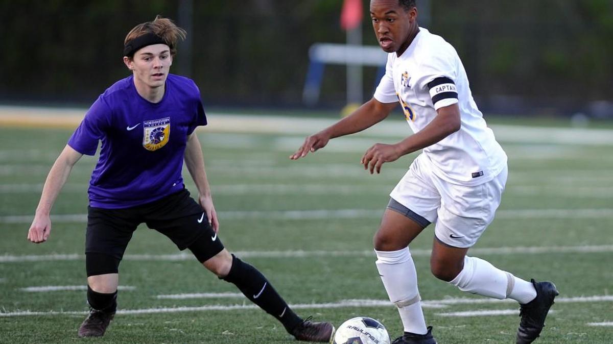 Fort Mill's Aaron Koch (16) works the ball across the pitch avoiding Northwestern’s defense.