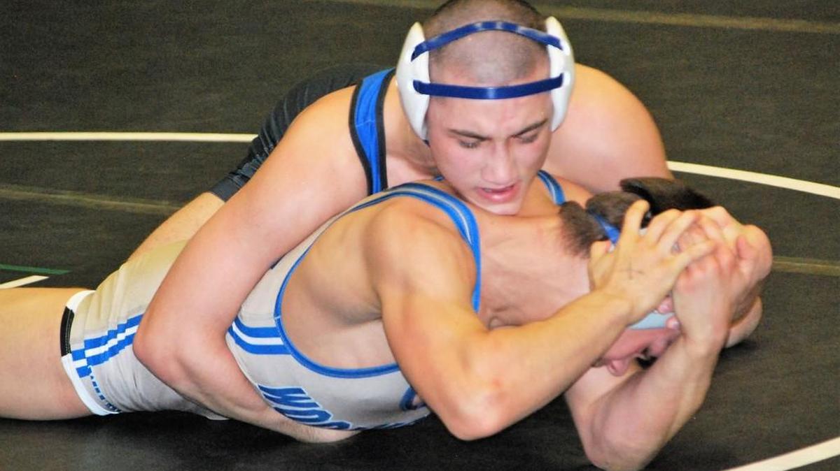 Fort Mill’s Jake Hart, top, wrestles in the finals of the 152-pound Upper State championship.