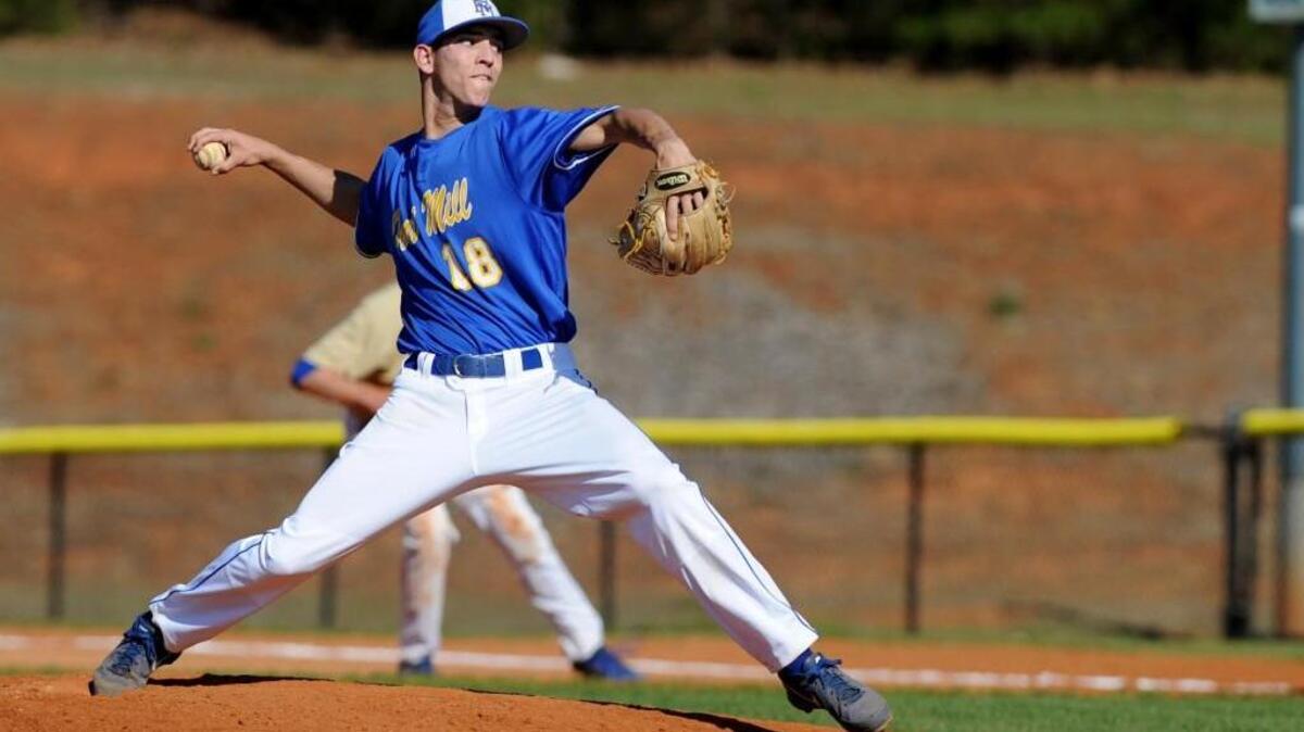 Fort Mill's pitcher Clay Helvey (18) on on the mound against Lewisville in the Wheels Baseball Invitational during his hiogh school days. Helvey has been drafted by the San Fransico Giants.