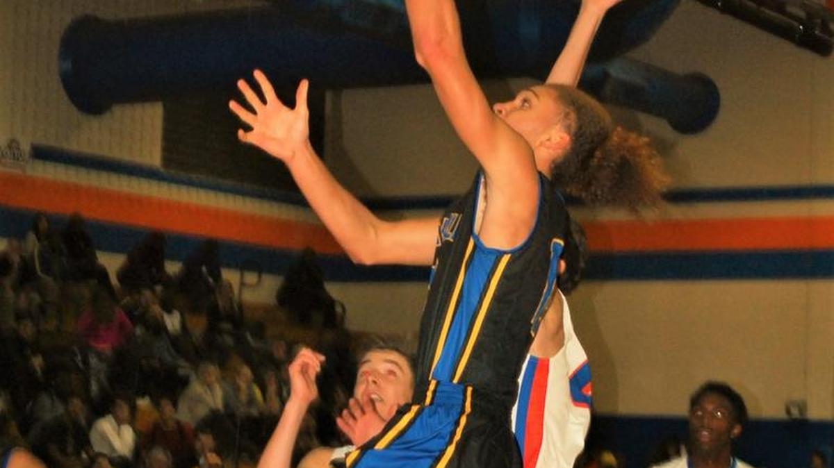 Fort Mill’s Keaton Griffin drives to the basket during a close win over Marvin Ridge.