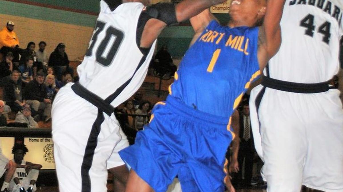 Fort Mill’s Jamal White gets fouled as he drives to the basket against Forestview. Fort Mill rode a fast start to its eighth win against only one loss.