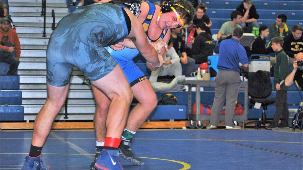 Fort Mill’s Jack Kelley, right, tries to tie up Lexington’s Austin Jennings in the finals of the 220-pound weight class in the Yellow Jackets Holiday Classic. Kelley went on to win the match.