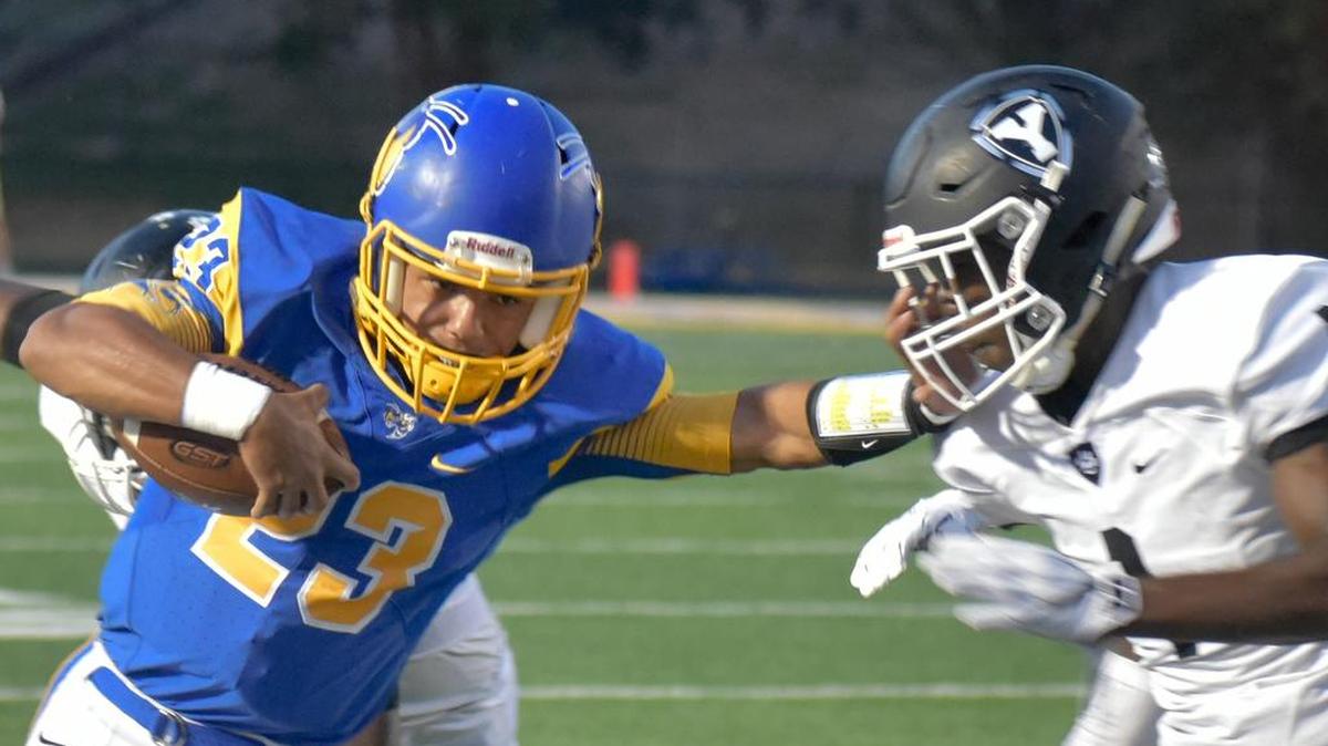 Ron'tavious Hughes, left, stiff-arms JaeVion Matthews during a run in Fort Mill's home game against York.