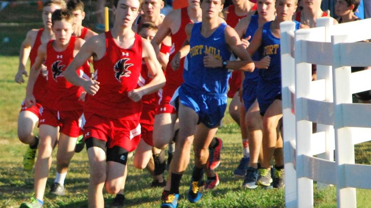 Fort Mill and Nation Ford boys round a corner during their cross country race on the Anne Springs Close Greenway.