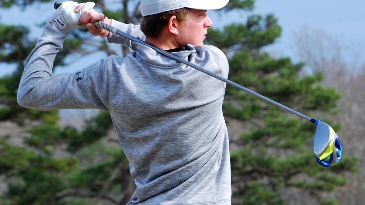 Fort Mill golfer Tyler Patterson hits golf ball off the driving range at Fort Mill Golf Club before the Jackets match with Northwestern.