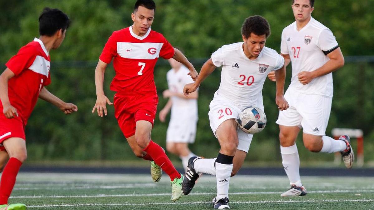 Nation Ford's Carter Richardson (20) breaks away from Greeville's Andree Funez in a second round 4A playoff soccer match. The Falcons won, but lost to Wade Hampton in the next round.