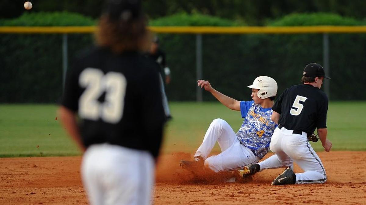 Kobie Mackinnon (4) of Fort Mill slides into second base and gets the steal due to an error on the throw. The Jackets rallied to win and stay alive in the 5A baseball playoffs.