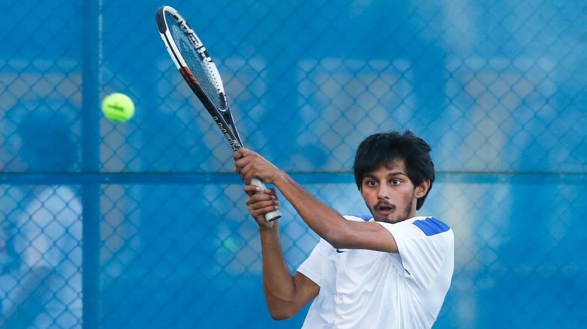 Fort Mill’s Sahil Maseh volleys with Clover’s Sean Elder.