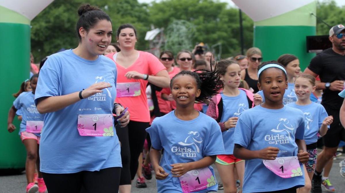 Girls, parents, coaches and volunteers sprint in the Girls on the Run Tri-County 5k non-competitive race in downtown Rock Hill. The organization is looking for coaches for the fall program.