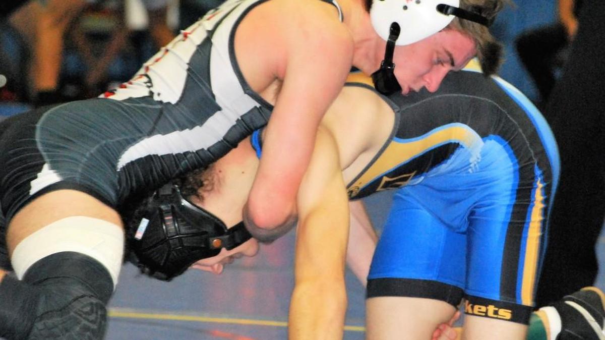 Jeremy Kishbaugh (top) finished second in the region at 120 pounds. His win in the semifianls was the 131st of his career, setting a new Nation Ford High School record.