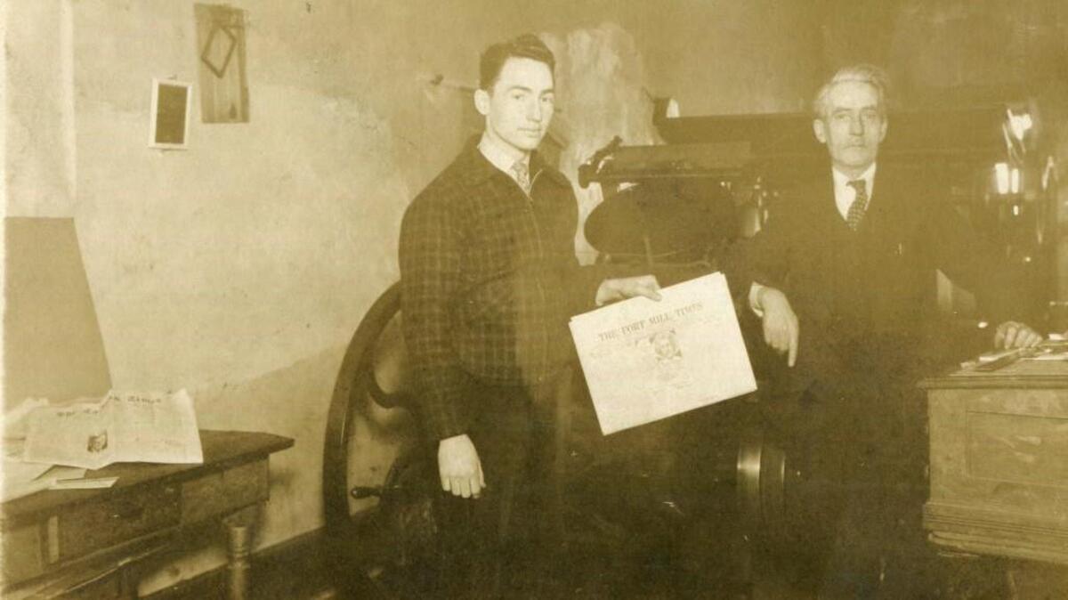 William Bradford Jr. and William Bradford Sr. pose with the first edition of the Fort Mill Times after ownership changed hands from father to son in 1943.