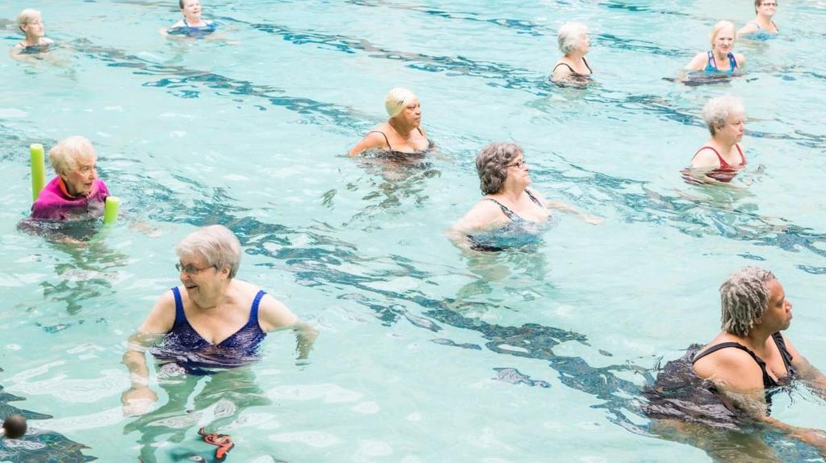 Members of the Water Aerobics class at Anne Springs Close Complex on the Greenway perform aquatic dance. On Tuesday morning, a joint news conference will be held at the Complex to announce “a new partnership which includes a multimillion dollar building project.”