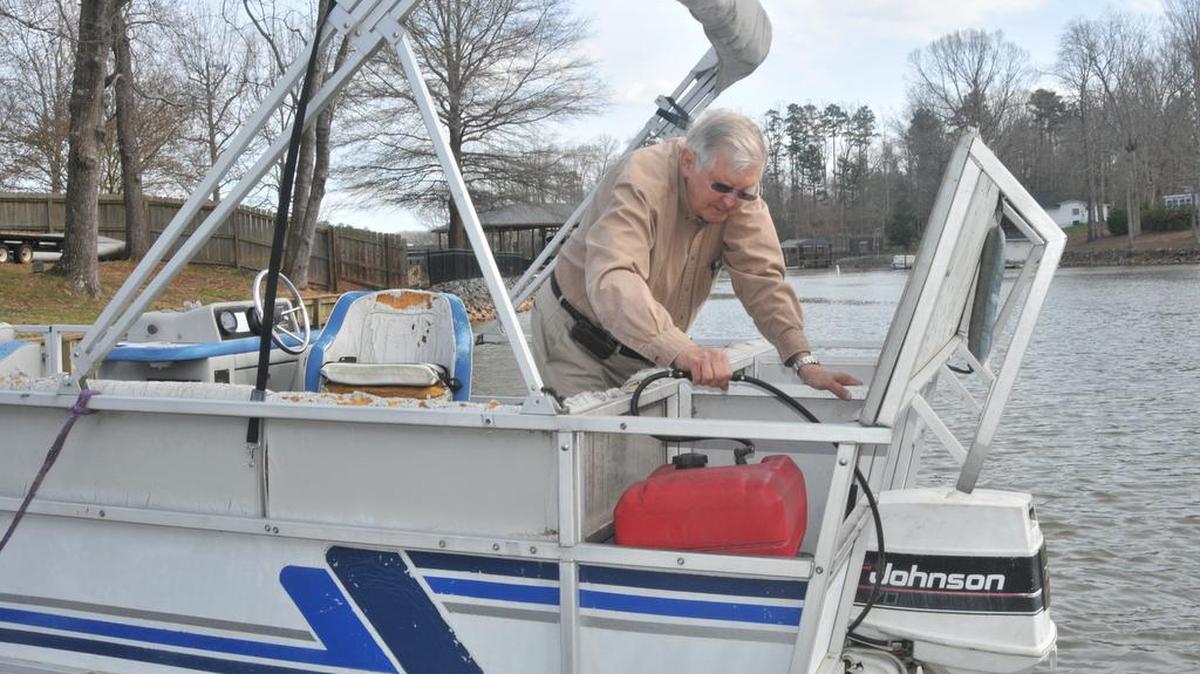 C.D. Collins works on boats Thursday he will sell, with proceeds going to the Catawba Riverkeeper Foundation.