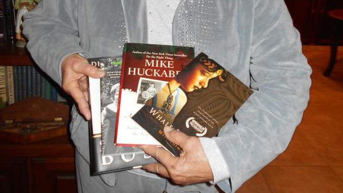 
Clover-Lake Wylie Republican Women’s Club member Carol Blackwell holds the four books the club donated to the Clover High School library. 
